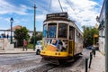 Romantic Lisbon street with the typical yellow tram, Portugal Royalty Free Stock Photo