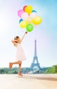 Romantic little girl with bright balloons in Paris