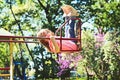 Romantic little girl on the swing, sweet dreams. Small kid playing in summer. childhood daydream .teen freedom Royalty Free Stock Photo