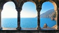 Romantic look at Portovenere on mediterranean sea through a historic medieval stone arch windows. Liguria . Italy