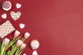 Romantic love background with tasty cupcakes and pink tulips. Copy space, overhead shot