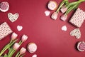 Romantic love background with tasty cupcakes and pink tulips. Copy space, overhead shot