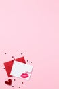 Romantic love letter concept. Blank paper card with lipstick kiss and red envelope on pastel pink background. Happy Valentines Day Royalty Free Stock Photo