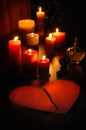 Love letter in shape of broken heart with candles and romantic old perfume bottle Royalty Free Stock Photo