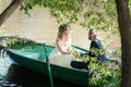 Romantic love story in boat. Woman with wreath and white dress. European tradition Royalty Free Stock Photo