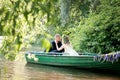 Romantic love story in boat. Woman with wreath and white dress. European tradition Royalty Free Stock Photo