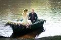 Romantic love story in boat. Woman with wreath and white dress. European tradition Royalty Free Stock Photo