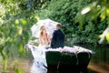 Romantic love story in boat. Woman with wreath and white dress. European tradition Royalty Free Stock Photo