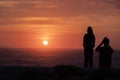 romantic lovers couple silhouettes. Beach photo shooting at sunset, man taking pictures of woman Royalty Free Stock Photo