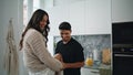 Romantic lovers laughing at domestic kitchen. Cheerful man feeding woman at home Royalty Free Stock Photo