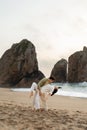 Romantic loving couple dancing on beach, enjoying their date on ocean shore, free space, full length, vertical shot Royalty Free Stock Photo