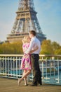 Romantic couple kissing near the Eiffel tower in Paris, France Royalty Free Stock Photo