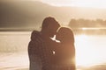 Romantic loving couple kissing at sunset