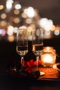 Romantic luxury evening with champagne setting with two glasses, rose petails and candles Royalty Free Stock Photo
