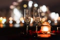 Romantic luxury evening with champagne setting with two glasses, rose petails and candles Royalty Free Stock Photo