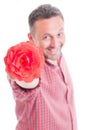 Romantic male offering flower