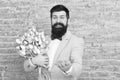 Romantic man with flowers. Romantic gift. Macho getting ready romantic date. Tulips for sweetheart. Man well groomed Royalty Free Stock Photo