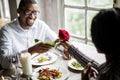 Romantic Man Giving a Rose to Woman on a Date Royalty Free Stock Photo