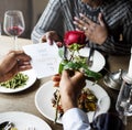 Romantic Man Giving a Rose to Woman on a Date Royalty Free Stock Photo