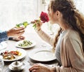 Romantic Man Giving a Rose to Woman on a Date Royalty Free Stock Photo