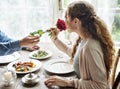 Romantic Man Giving a Rose to Woman on a Date Royalty Free Stock Photo