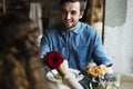 Romantic Man Giving a Rose to Woman on a Date