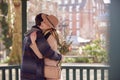 Romantic Man Hugging Young Woman After Giving Her Bouquet Of Flowers As They Meet In City Park Royalty Free Stock Photo