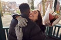 Romantic Man Hugging Young Woman After Giving Her Bouquet Of Flowers As They Meet In City Park Royalty Free Stock Photo