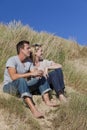 Romantic Man & Woman Couple Sitting On Beach Royalty Free Stock Photo
