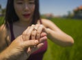 Romantic marriage proposal . close up hands of happy Asian couple in love holding together , the woman with engagement ring on her Royalty Free Stock Photo