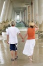 Romantic mature man & woman holding hands walking on beach Royalty Free Stock Photo
