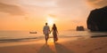 Romantic middle aged couple enjoying beautiful sunset walk on the beach travel vacation, Krabi Thailand