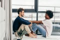 Romantic mixed race couple standing by the window thinking about their future. Royalty Free Stock Photo