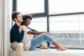 Romantic mixed race couple standing by the window thinking about their future. Royalty Free Stock Photo