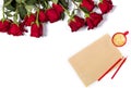 Romantic mockup. Beautiful bunch of large red roses, sheet of craft paper, color pencils and small cup of coffee on white Royalty Free Stock Photo