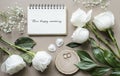 Romantic mockup with flowers and a notebook on a beige background.