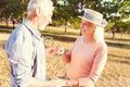 Adorable elderly couple dancing in park