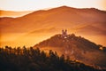 Romantic morning scenery - church with two towers on the top of the hill in beautiful warm summer morning light. Fairy tail photo Royalty Free Stock Photo