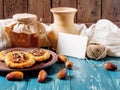 Romantic morning still life, in a rustic style with cookies, honey , dates , milk jug and card