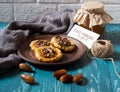 Romantic morning still life in a rustic style with cookies, honey and dates on a turquoise wooden background