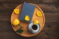 Romantic morning. Wooden tray with book, rose, cup of coffee, on wooden background Royalty Free Stock Photo