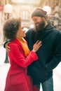 Romantic multiethnic couple in love hugging on the street Royalty Free Stock Photo