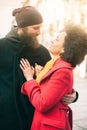 Romantic multiethnic couple in love hugging on the street Royalty Free Stock Photo