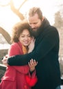 Romantic multiethnic couple in love hugging on the street Royalty Free Stock Photo