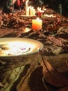 Romantic,mystic candles on the wooden platform with aurumn leaves