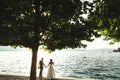 Romantic newlywed couple bride and groom at sunset beach near se Royalty Free Stock Photo