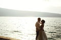 Romantic newlywed couple bride and groom at sunset beach near se Royalty Free Stock Photo