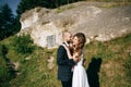 Romantic newlywed couple hugging near old mountain city. Love concept Royalty Free Stock Photo