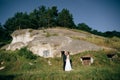 Romantic newlywed couple hugging near old mountain city. Love concept Royalty Free Stock Photo