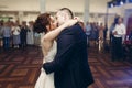 Romantic newlywed couple kissing after first dance at wedding reception, handsome groom hugging sensual bride, wedding moment Royalty Free Stock Photo